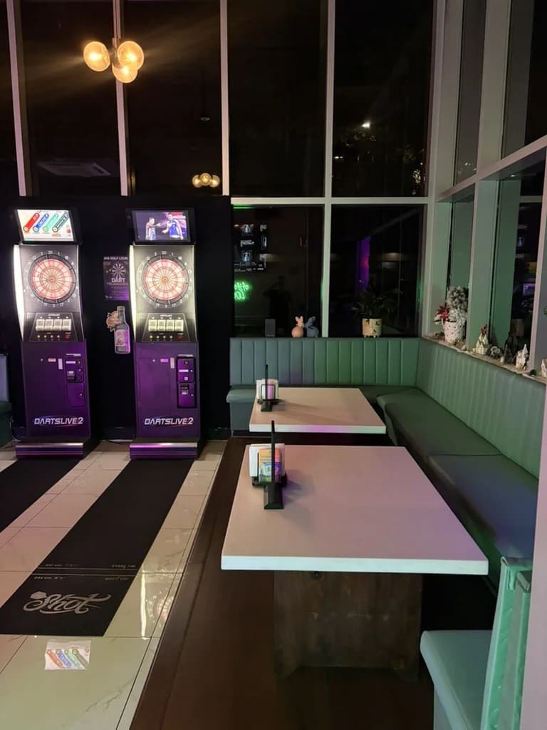 DartsLive2 dart machines and booth seating at Aya Golf Lounge Honolulu — venue for the monthly dart tournament