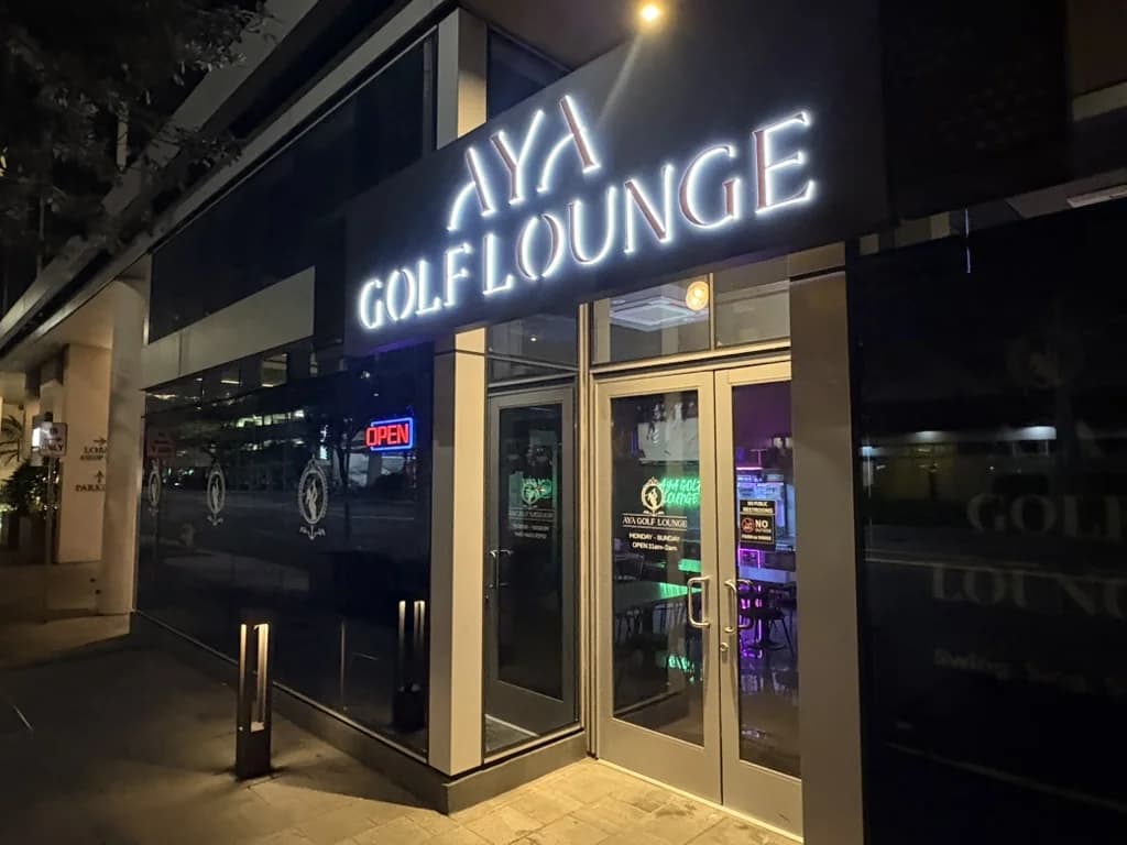 Aya Golf Lounge exterior sign at night on Keʻeaumoku Street, Honolulu