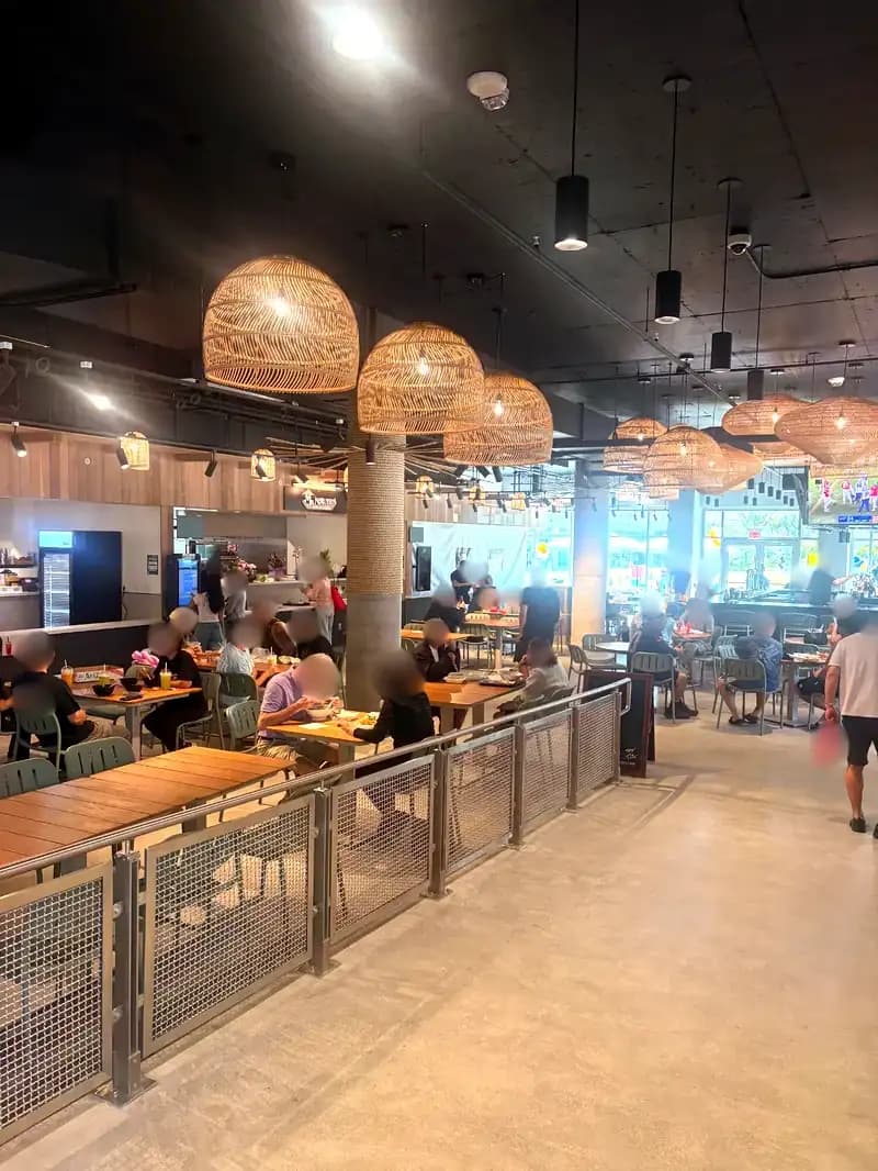 Midtown Eats interior packed with customers on grand opening day with K Park Bar showing NFL playoffs