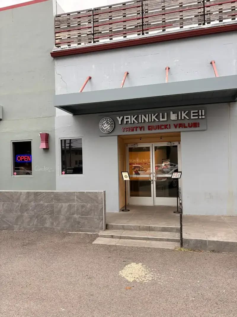 Yakiniku Like Hawaii storefront entrance on Ke'eaumoku Street in Honolulu showing OPEN sign and Tasty Quick Value slogan
